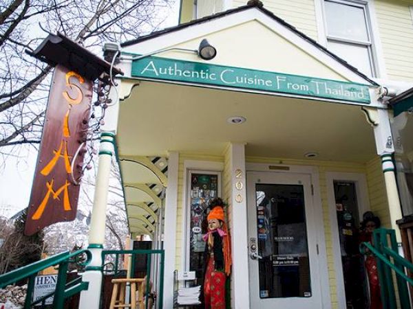 It's a Thai restaurant exterior with a sign "Authentic Cuisine from Thailand".