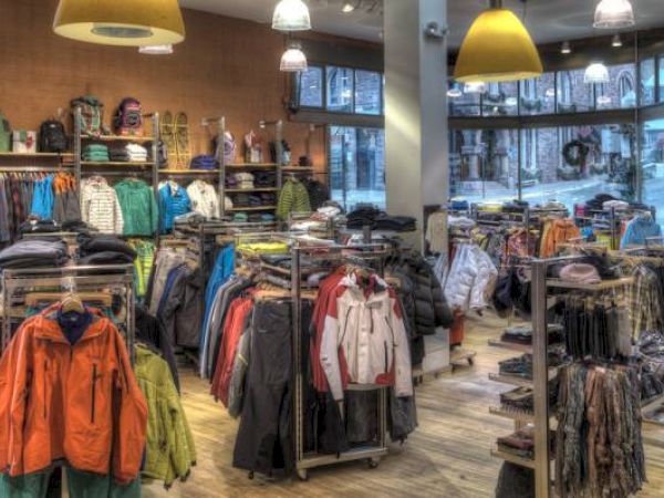 A clothing store interior with racks of jackets and assorted apparel.