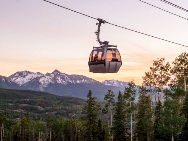 A gondola against a mountain backdrop during sunset in Telluride Colorado.