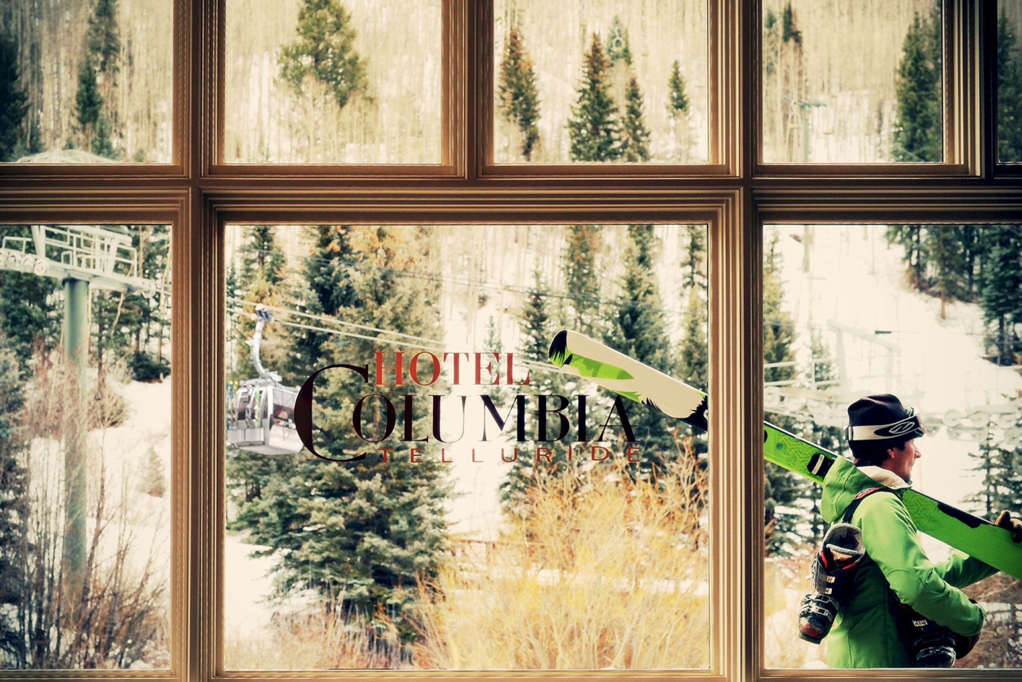 Window at Hotel Columbia Telluride showcasing snowy landscape with trees.