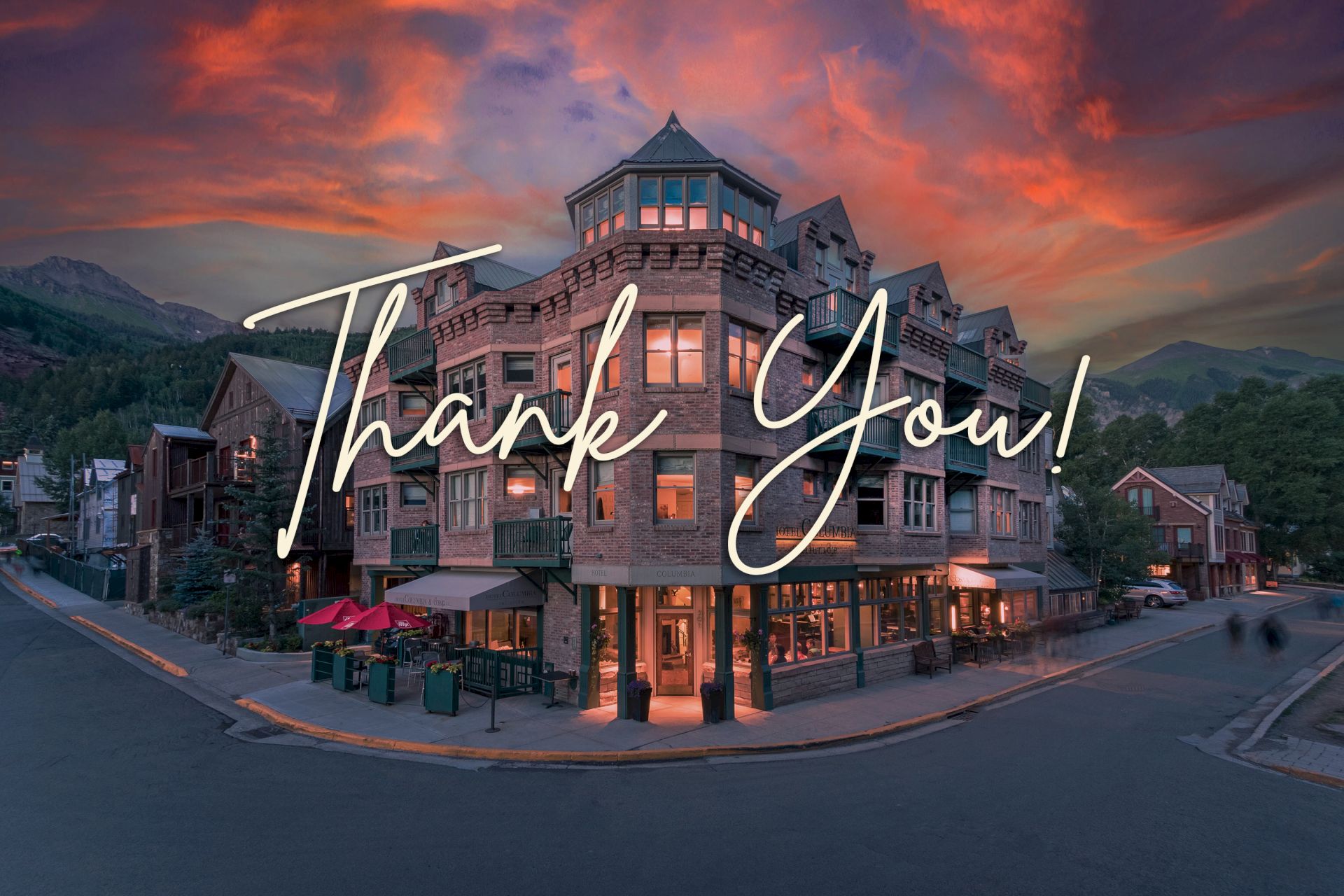 A street corner with a quaint building at sunset and the words "Thank You!" written across the image.